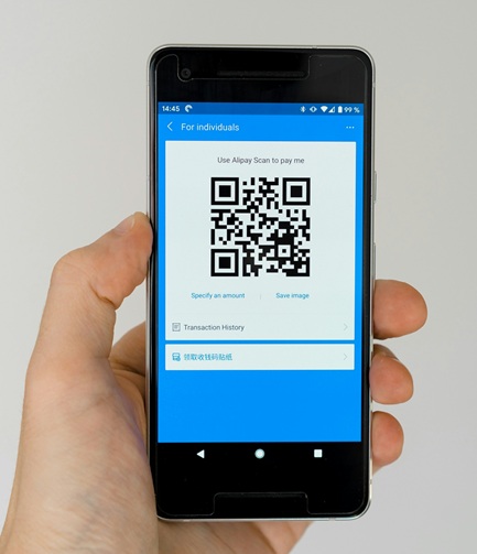 Guest scanning a QR code on a phone to upload event photos